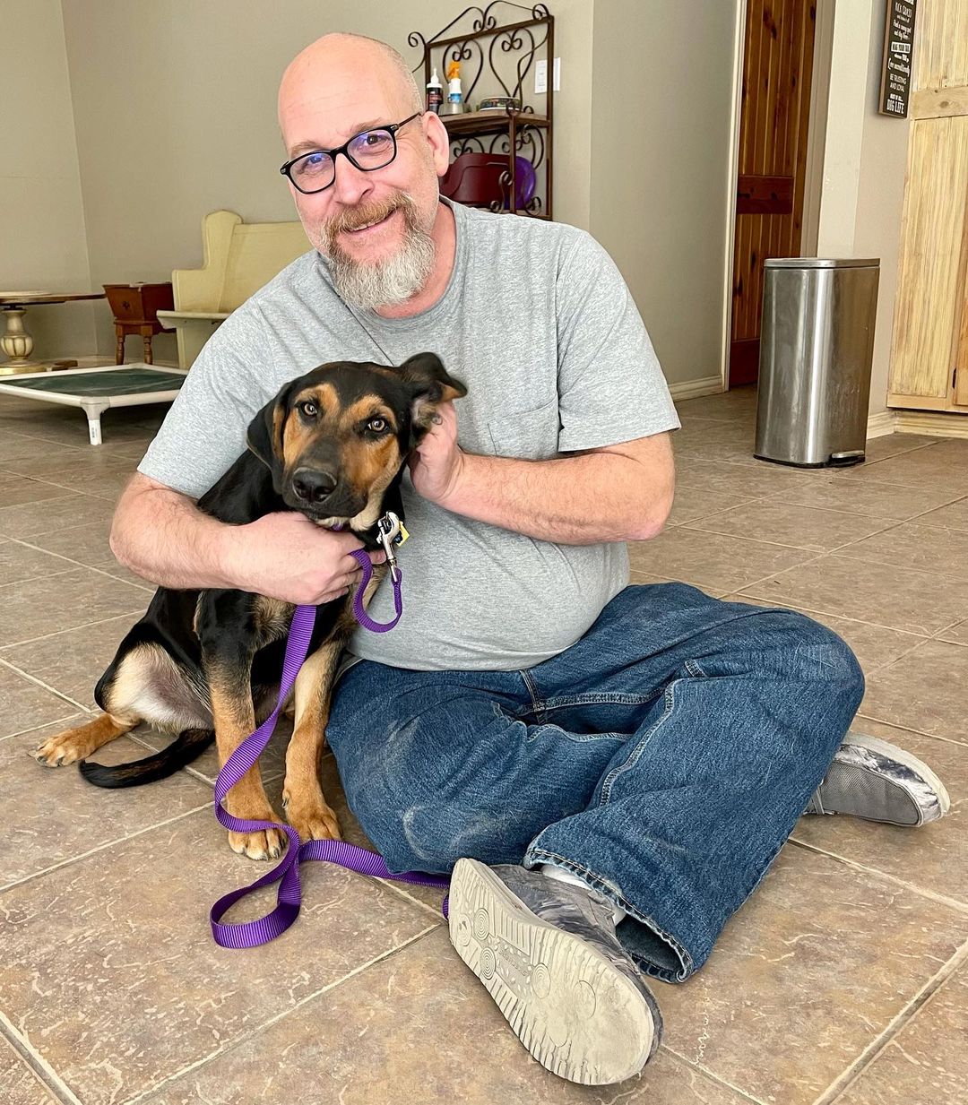 Nigel in the arms of his adoptive Dad. Two more siblings are also available for adoption.